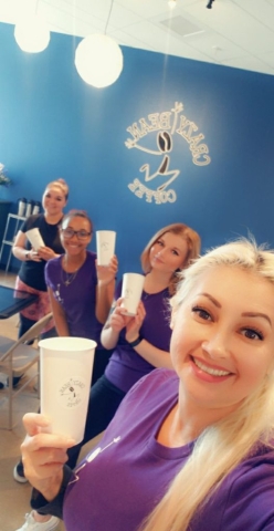 crazy bean employees posing in their uniforms wiht coffee cups