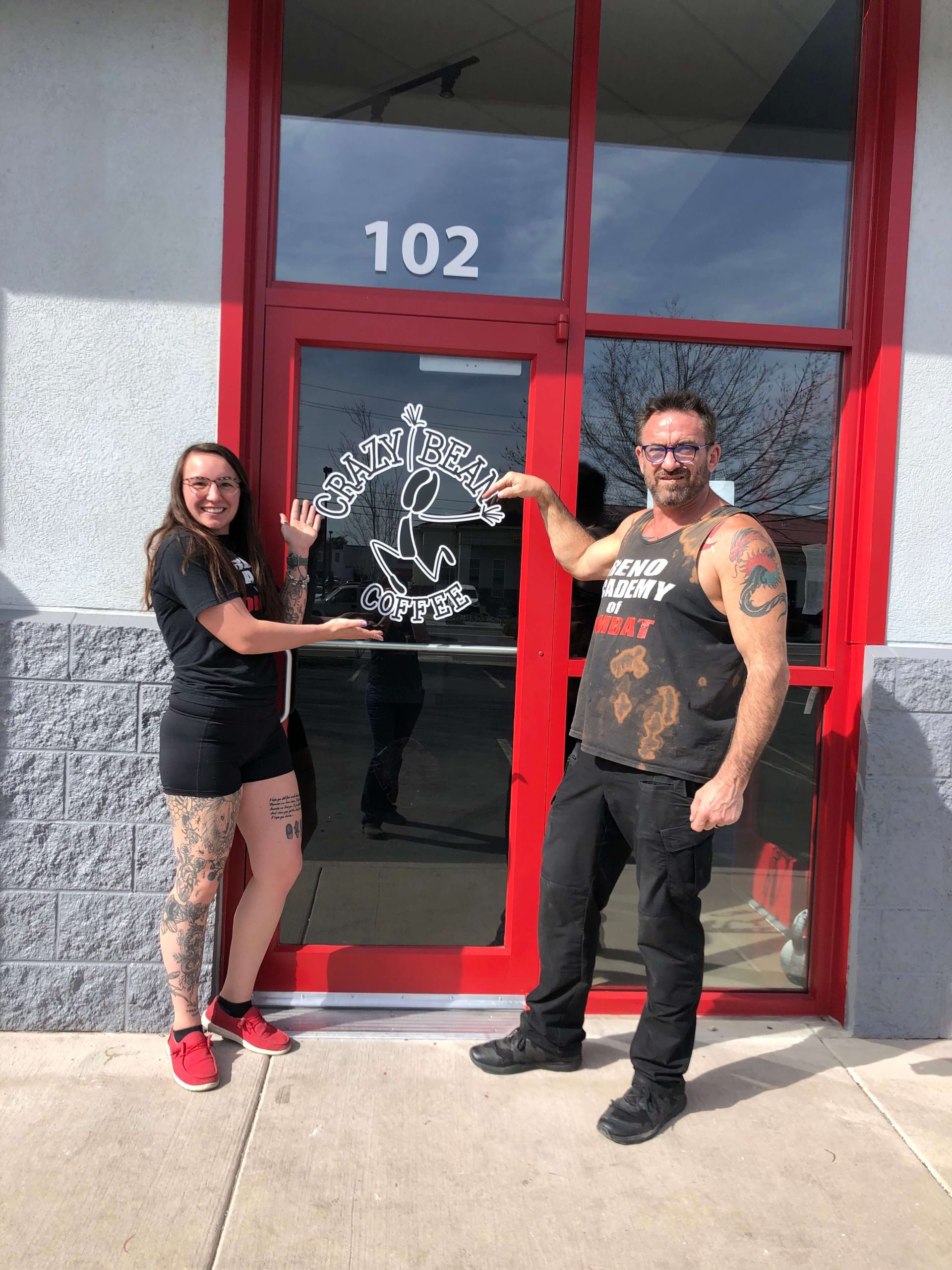 darien and rick posing in front of the crazy bean door